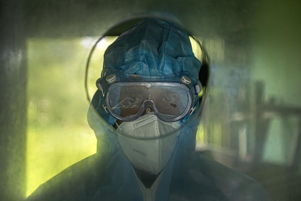 An Indian health worker waits to collect nasal swab samples at a COVID-19 testing center in Gauhati, Assam state, India, Sunday, July 12, 2020. India is the world’s third worst-affected count