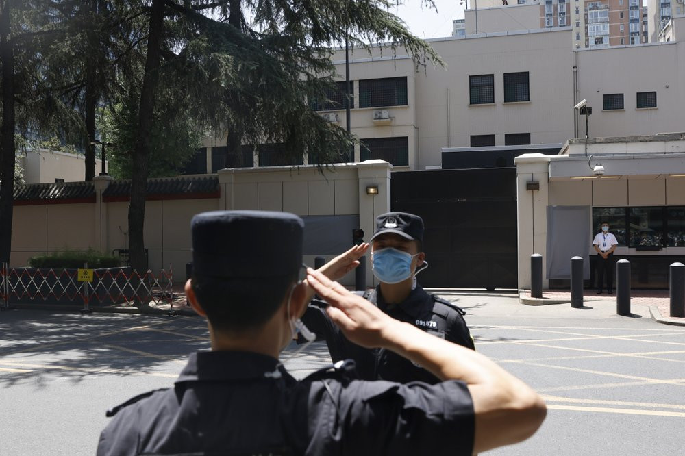 Chinese SWAT officers salute each other at the former United States Consulate in Chengdu in southwest China's Sichuan province on Monday, July 27, 2020 after Chinese authorities took control 
