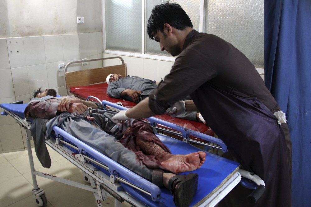 A wounded man receives treatment at a hospital after a suicide car bomb and multiple gunmen attack in the city of Jalalabad, east of Kabul, Afghanistan, Sunday, Aug. 2, 2020.