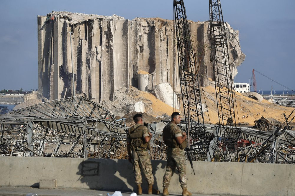 Lebanese army soldiers stand guard at the scene where an explosion hit on Tuesday the seaport of Beirut, Lebanon, Thursday, Aug. 6, 2020.