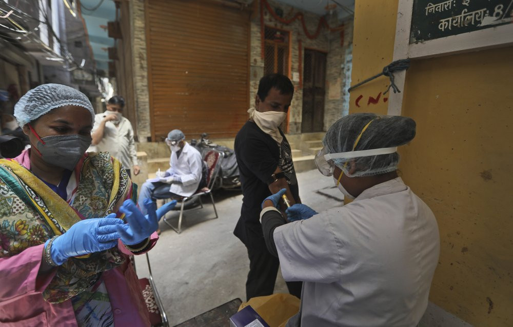 Health workers take blood samples for a random serological test to check for antibodies against the coronavirus in New Delhi, India, Thursday, Aug. 6, 2020.
