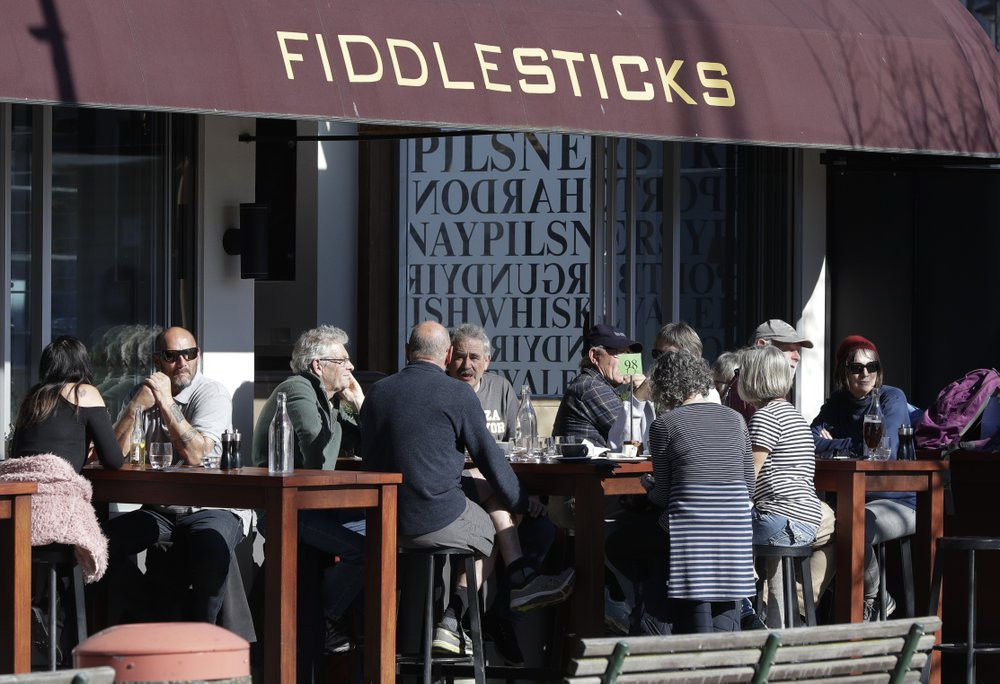 Customers at a cafe enjoy lunch in the sunshine in Christchurch, New Zealand, Sunday, Aug. 9, 2020. New Zealand marked a 100 days of being free from the coronavirus in its communities Sunday.
