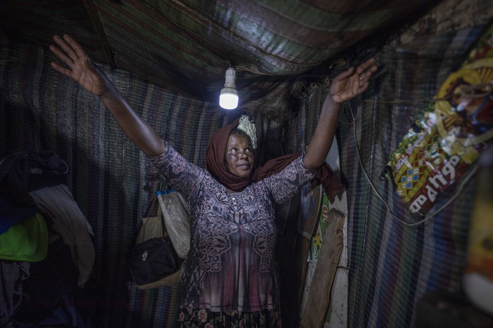 Mother of two Amsale Hailemariam, a domestic worker who lost work because of the coronavirus, stands in her small tent in the capital Addis Ababa, Ethiopia on Friday, June 26, 2020.