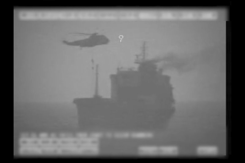 In this image made from video released by the U.S. military's Central Command, Iranian commandos fast-rope down from a helicopter onto the MV Wila oil tanker in the Gulf of Oman off the coast