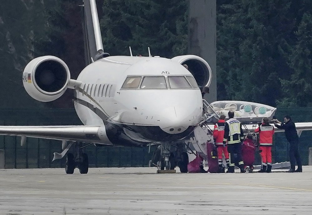 A stretcher is taken from special aircraft with the Kremlin critic Alexei Navalny on board at Tegel Airport in Berlin, Germany, Saturday, Aug.22, 2020.