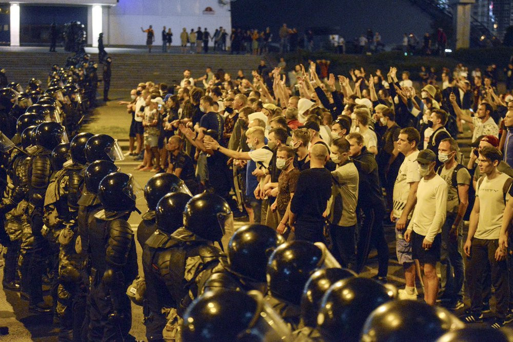 In this file photo taken on Sunday, Aug. 9, 2020, people argue with police during a rally after the Belarusian presidential election in Minsk, Belarus.