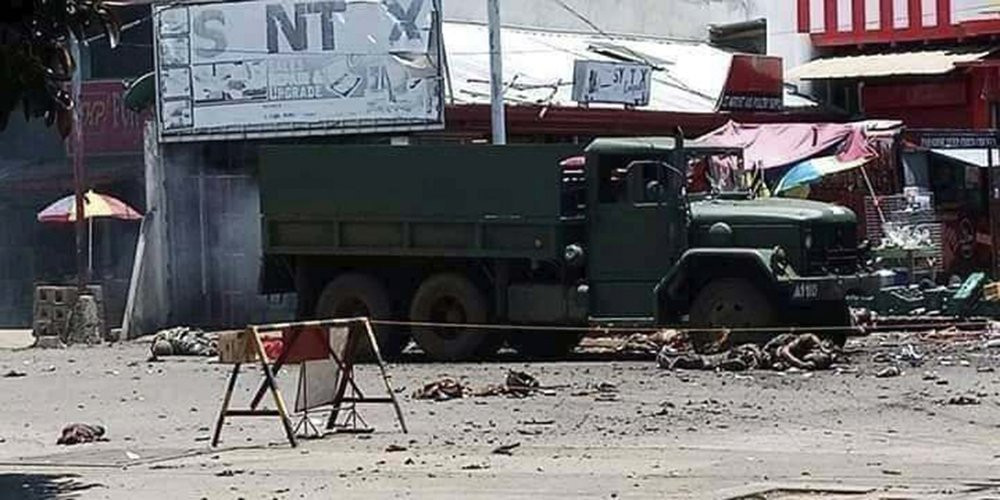 In this photo provided by the Philippine Red Cross, a military truck lies at an area where a bomb exploded at the town of Jolo, Sulu province, southern Philippines, Monday, Aug. 24, 2020.