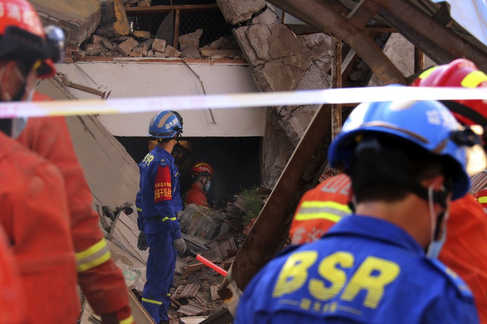 Rescuers search for victims in the aftermath of the collapse of a two-story restaurant in Xiangfen county in northern China's Shanxi province on Saturday, Aug. 29, 2020.