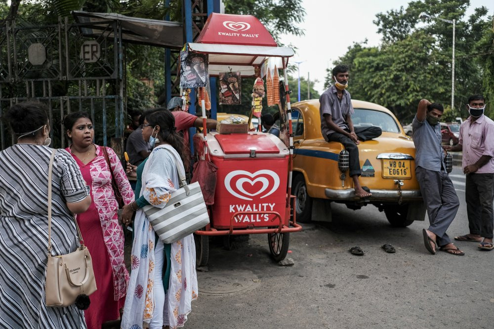 Taxi drivers wearing face masks wait for passengers in Kolkata, India, Saturday, Aug. 29, 2020. India has the third-highest coronavirus caseload after the United States and Brazil, and the fo