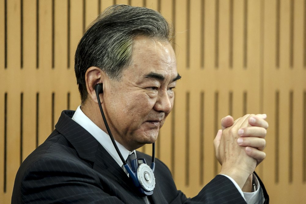 Chinese Foreign Minister Wang Yi greets the audience prior a press conference at the Institute for International Relations in Paris, Sunday, Aug. 30, 2020.