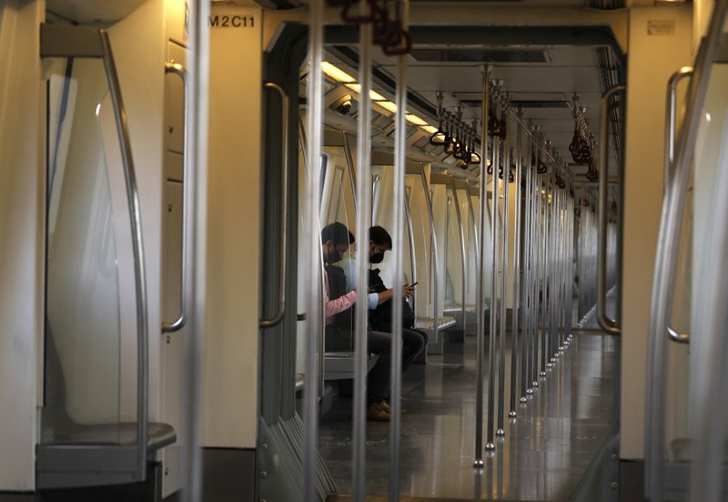 Commuters travel in an almost empty Delhi metro train in New Delhi, India, Monday, Sept. 7, 2020.