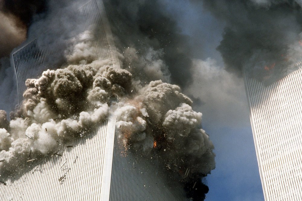 In this Sept. 11, 2001, file photo, the south tower of the World Trade Center, left, begins to collapse after a terrorist attack on the landmark buildings in New York.