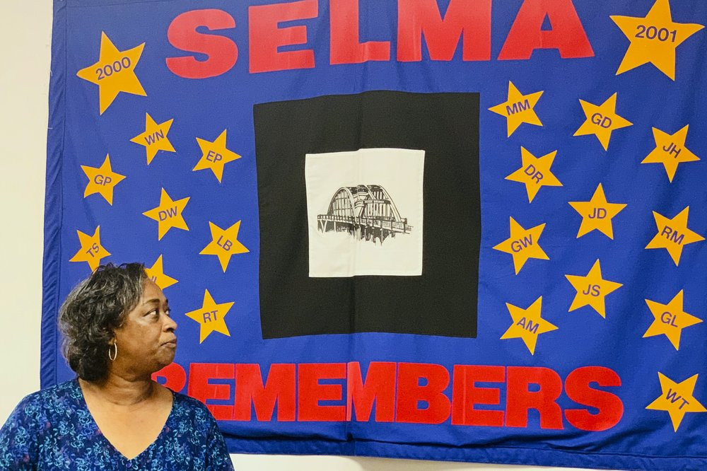 Mel Prince, executive director of Selma AIR, looks at a quilt that remembers people who lost their lives to AIDS, at her office in Selma, Ala., on Sept 3, 2020.