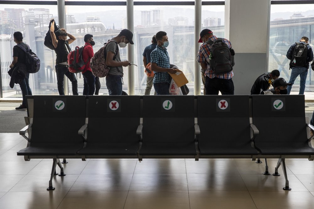Passengers wait to board a humanitarian flight to Canada at the La Aurora international airport in Guatemala City, Thursday, Sept. 17, 2020.