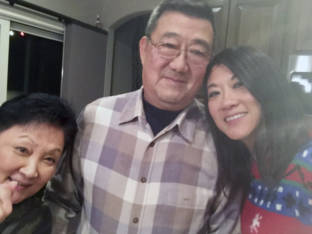 This December 2016 photo provided by the family shows, from left, Lu Wang, Ming Wang and Anne Peterson. Ming Wang, 71, was sickened in March 2020 on a cruise from Australia with his wife.