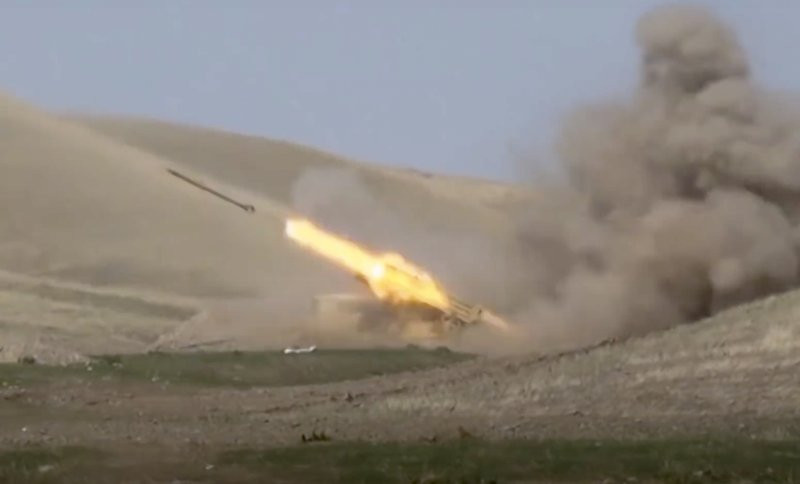 In this image taken from footage released by Azerbaijan's Defense Ministry on Sunday, Sept. 27, 2020, an Azerbaijan's rocket launches from missile system at the contact line of the self-procl