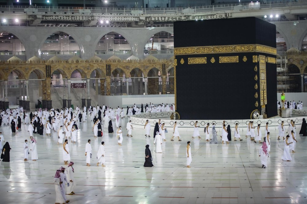 In this photo released by Saudi Ministry of Hajj and Umrah, Muslims pray around the Kaaba, the cubic building at the Grand Mosque, during the first day of Umrah in the Muslim holy city of Mec