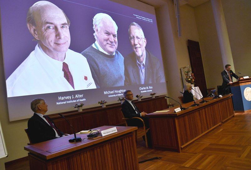 Thomas Perlmann, far right, Secretary of the Nobel Assembly announces the 2020 Nobel laureates in Physiology or Medicine during a news conference at the Karolinska Institute in Stockholm, Swe