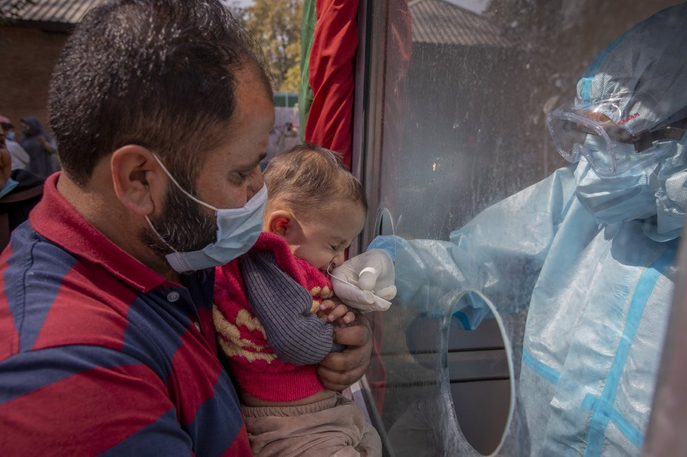 A Kashmiri health worker takes a nasal swab sample of a child to test for COVID-19 in Srinagar, Indian-controlled Kashmir, Tuesday, Oct. 6, 2020. India is the second worst-nation in terms of 
