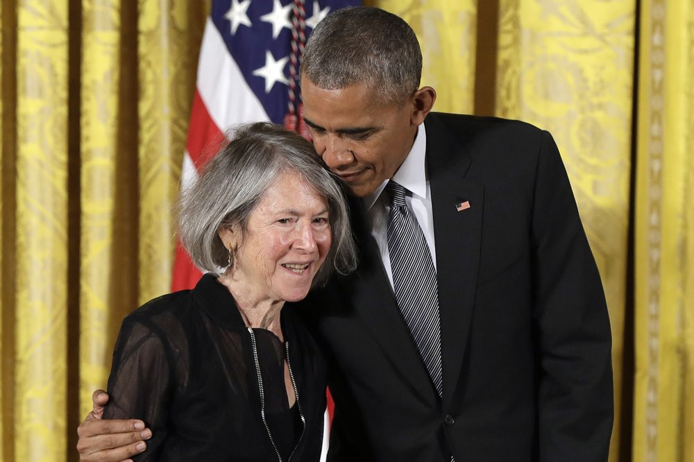 In this Thursday, Sept. 22, 2016 file photo, President Barack Obama embraces poet Louise Gluck before awarding her the 2015 National Humanities Medal during a ceremony in the East Room of the