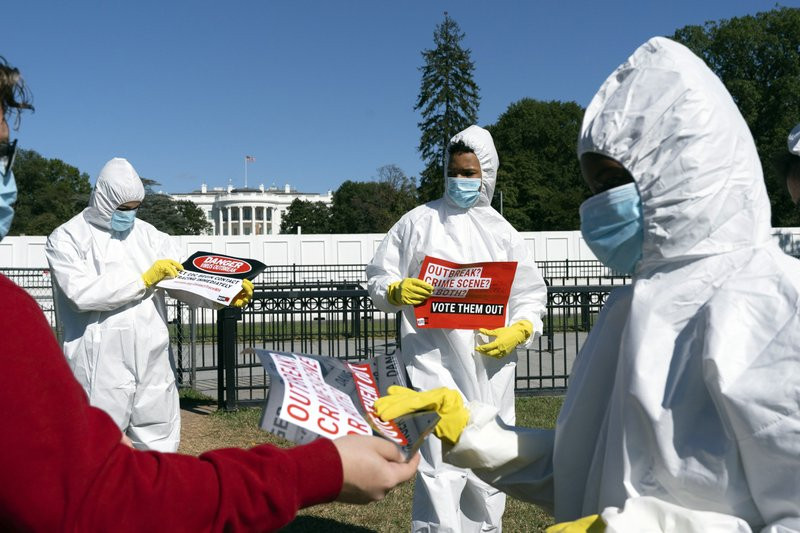 A group protests the ongoing outbreak of coronavirus in the White House, Thursday, Oct. 8, 2020, outside the White House in Washington.