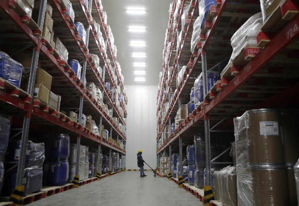 A worker moves boxes at Snowman Logistics, India's largest cold storage company in Taloja, on the outskirts of Mumbai, India, Saturday, Oct. 17, 2020.