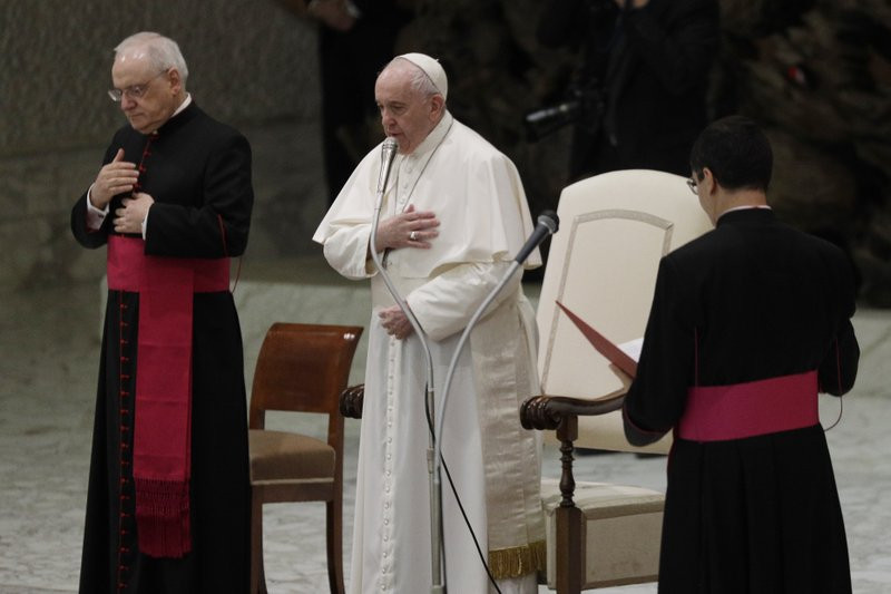 Pope Francis, center, makes the sign of the cross during his weekly general audience in the Paul VI hall at the Vatican, Wednesday, Oct. 21, 2020.