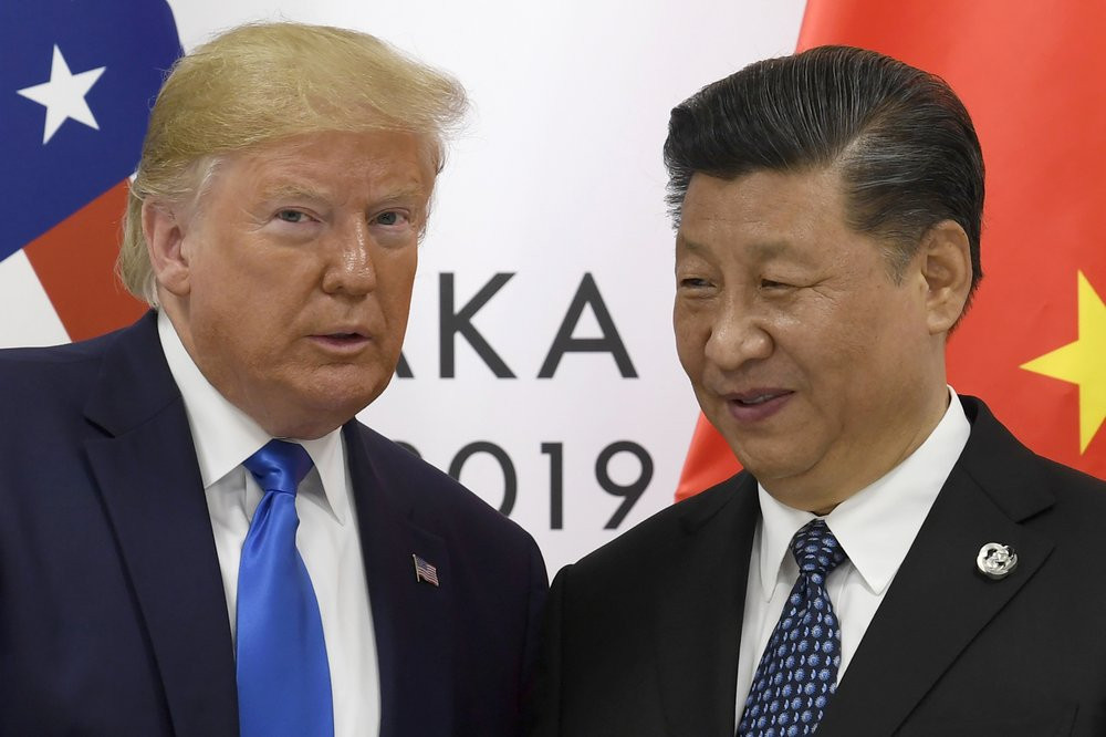 In this June 29, 2019, file photo, U.S. President Donald Trump poses for a photo with Chinese President Xi Jinping during a meeting on the sidelines of the G-20 summit in Osaka, western Japan