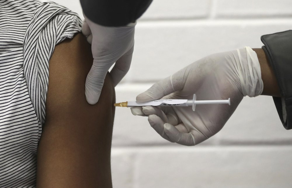 In this Wednesday, June 24, 2020 file photo, a volunteer receives AstraZeneca vaccine at the Chris Hani Baragwanath hospital in Soweto, Johannesburg.