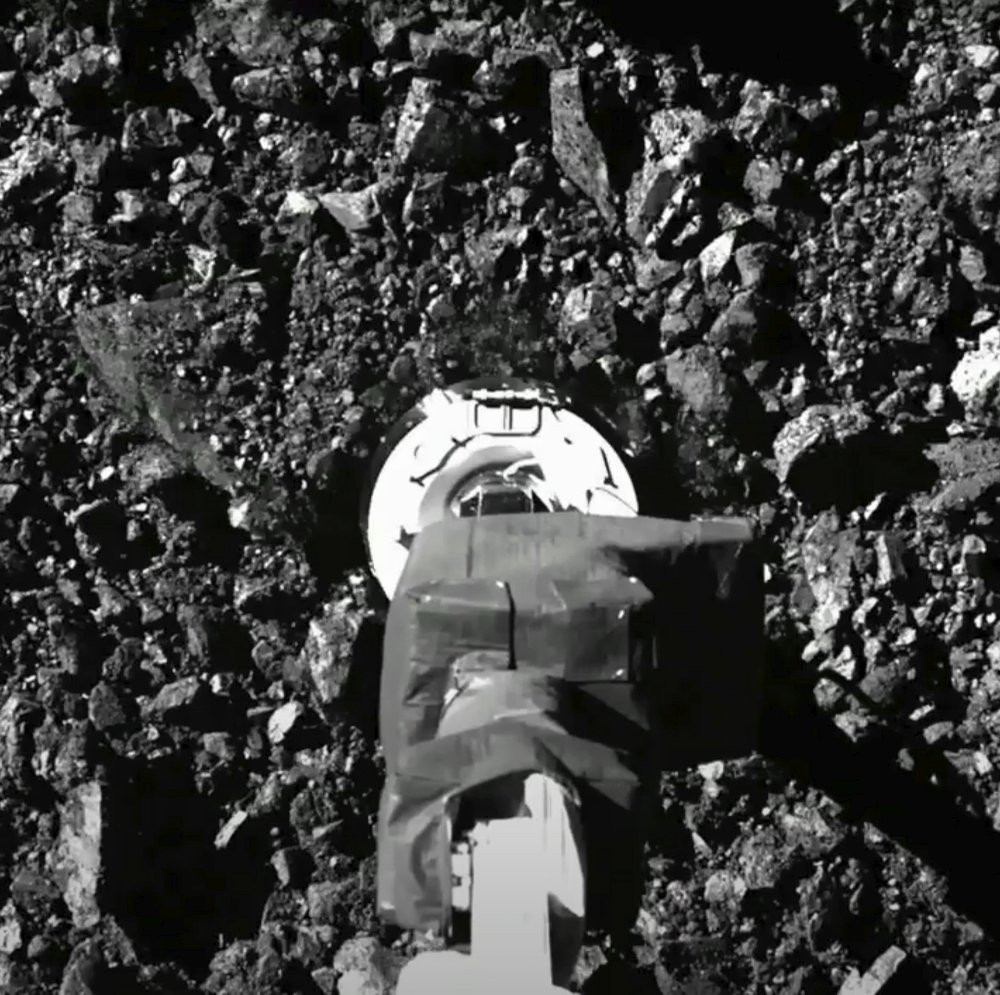 In this image taken from video released by NASA, the Osiris-Rex spacecraft touches the surface of asteroid Bennu on Tuesday, Oct. 20, 2020.