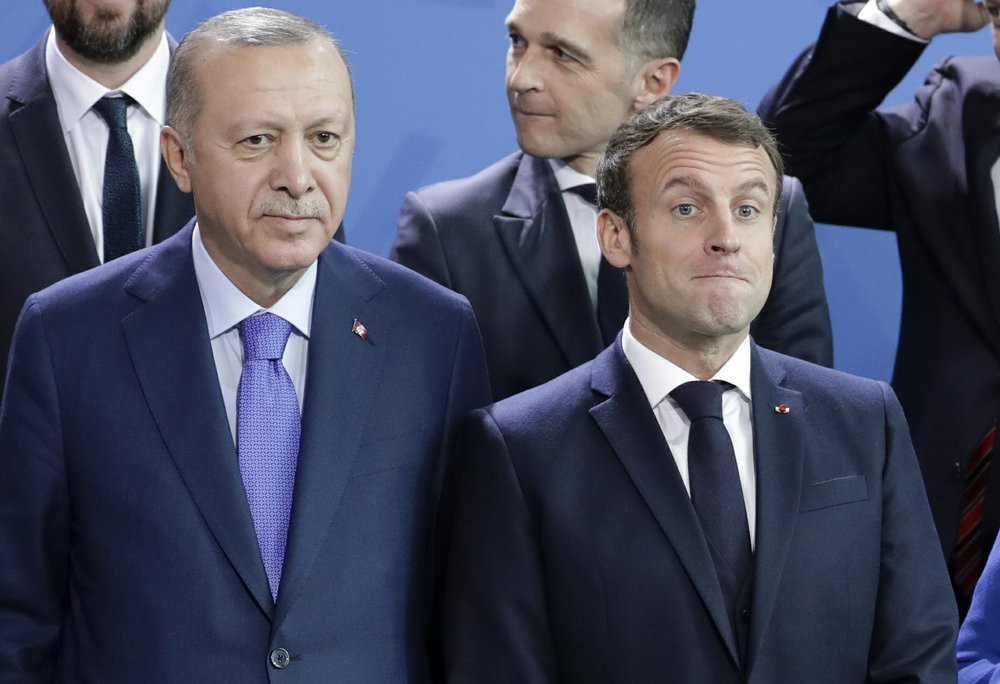 In this Sunday, Jan. 20, 2020 file photo, Turkey's President Recep Tayyip Erdogan, left and French President Emmanuel Macron stand, during a group photo at a conference on Libya at the chance