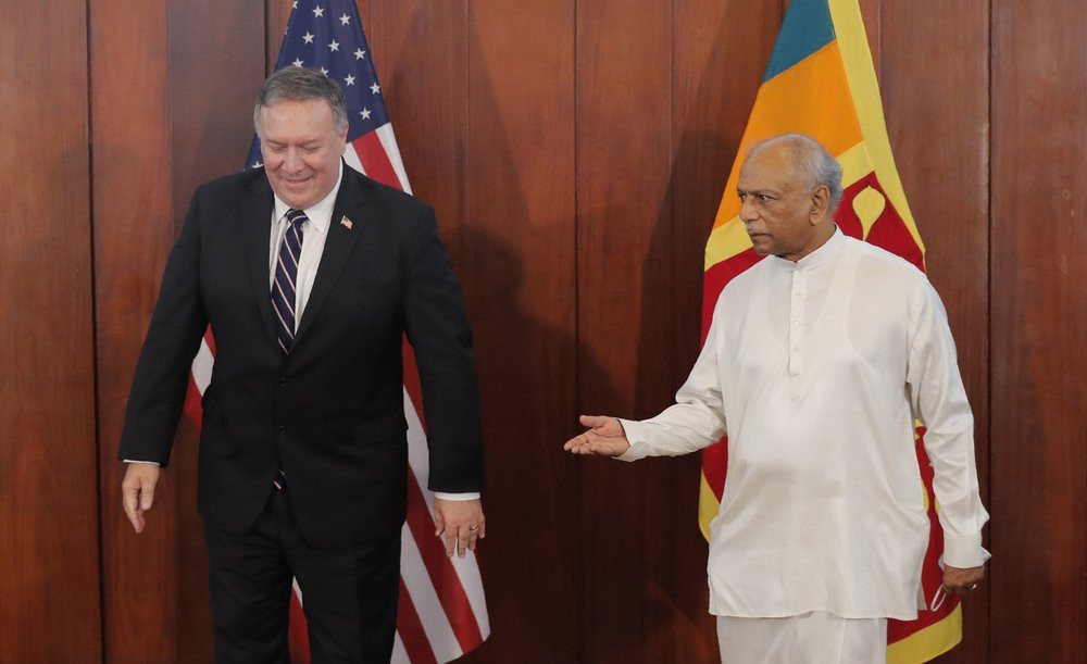 Sri Lankan Foreign Minister Dinesh Gunawardena gestures towards U.S. Secretary of State Mike Pompeo before their meeting in Colombo, Sri Lanka, Wednesday, Oct. 28, 2020.