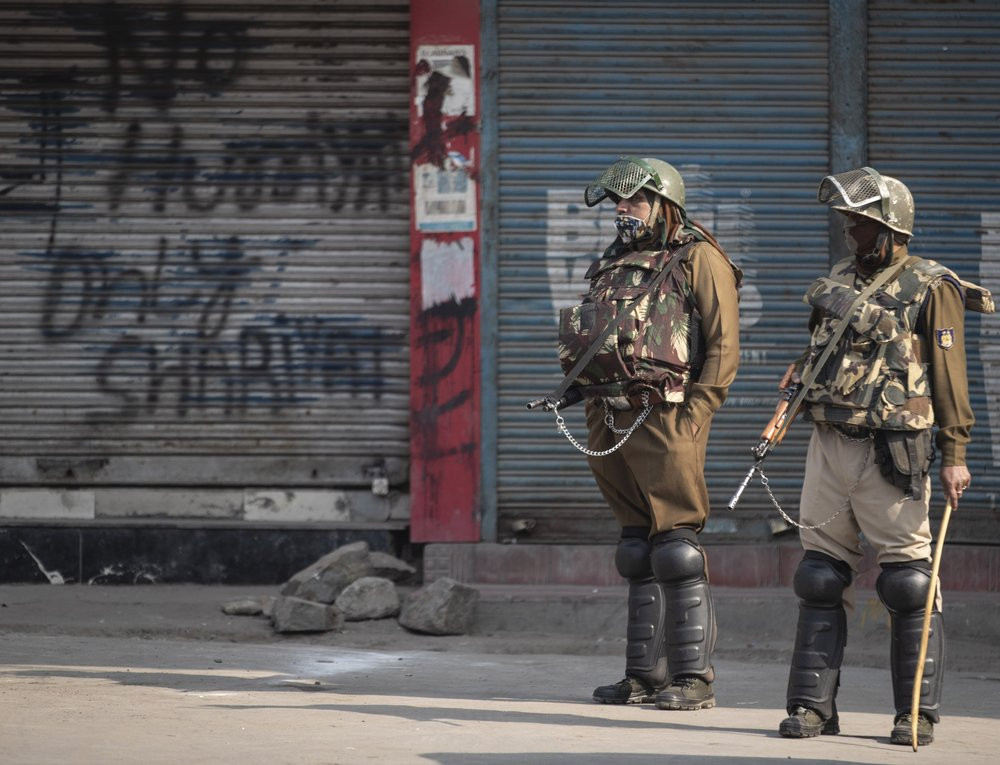 Indian paramilitary soldiers stand guard at a closed market area during a strike called by separatists in Srinagar, Indian controlled Kashmir, Saturday, Oct. 31, 2020.