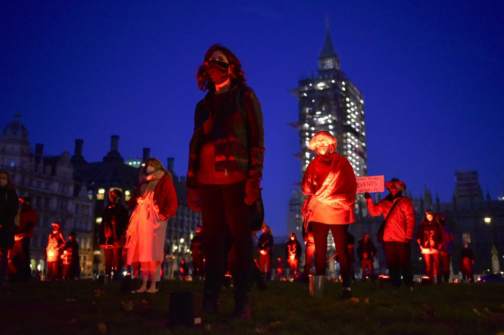 Demonstrators hold a silent vigil in Parliament Square to rise awareness on entertainment and arts world, in London, Saturday, Oct. 31, 2020.