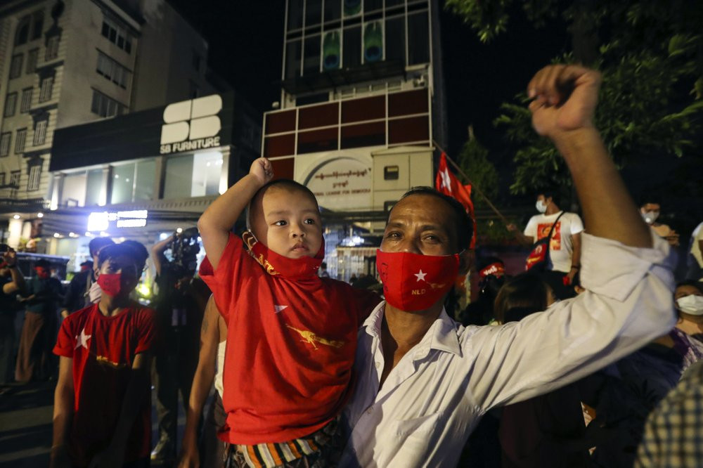 Supporters wearing face mask cheer as they gather in front of Myanmar Leader Aung San Suu Kyi's National League for Democracy (NLD) party's headquarters during Election Day Sunday, Nov. 8, 20