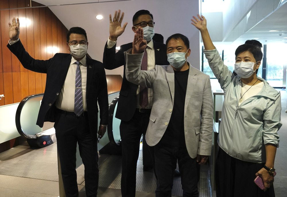 Pro-democracy legislators, from right, Wong Pik Wan, Wu Chi Wai, Lam Cheuk-ting, Yoon Siu Kin wave after handing their letters at Legislative Council in Hong Kong, Thursday day, Nov. 12, 2020