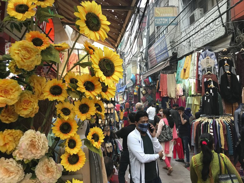 People shop ahead of Diwali, the Hindu festival of lights, at the Lajpat Nagar market in New Delhi, India, Monday, Nov. 9, 2020.