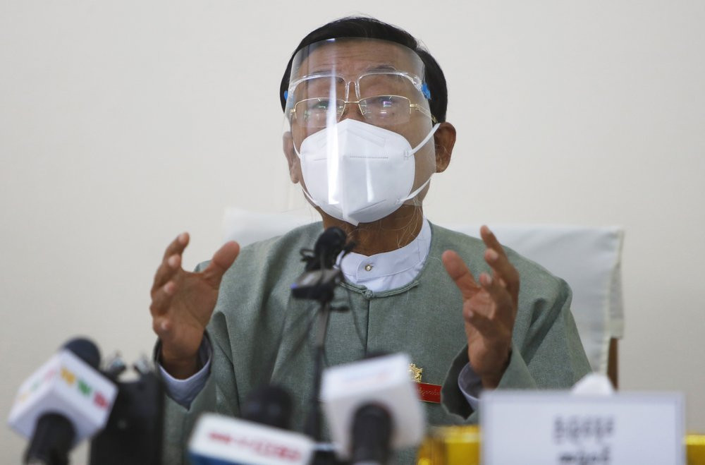 Myint Naing, a member of the Union Election Commission, wearing a protective face mask and shield, gestures as he delivers a speech during an event to announce election results Wednesday, Nov