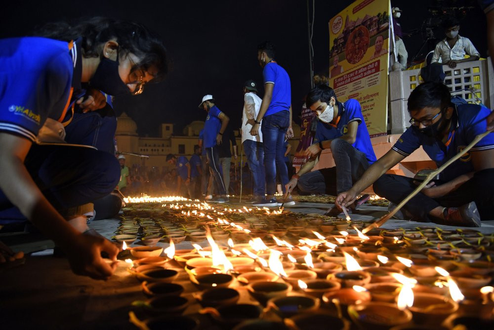 People light lamps on the banks of river Saryu in Ayodhya, India, Friday, Nov. 13, 2020.