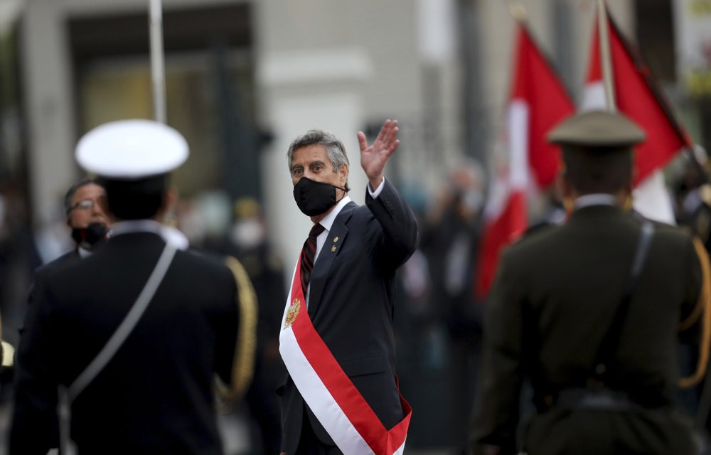 Francisco Sagasti waves after being sworn-in as the new, interim president at Congress in Lima, Peru, Tuesday, Nov. 17, 2020.