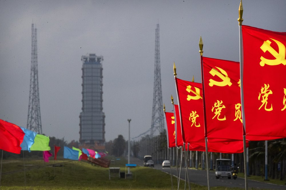 Flags with the logo of the Communist Party of China fly in the breeze near a launch pad at the Wenchang Space Launch Site in Wenchang in southern China's Hainan province, Monday, Nov. 23, 202