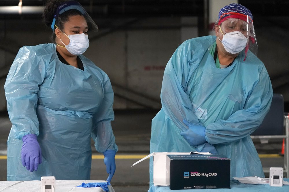 Nurses check on the status of rapid COVID-19 tests at a drive-through testing site in a parking garage in West Nyack, N.Y., Monday, Nov. 30, 2020.