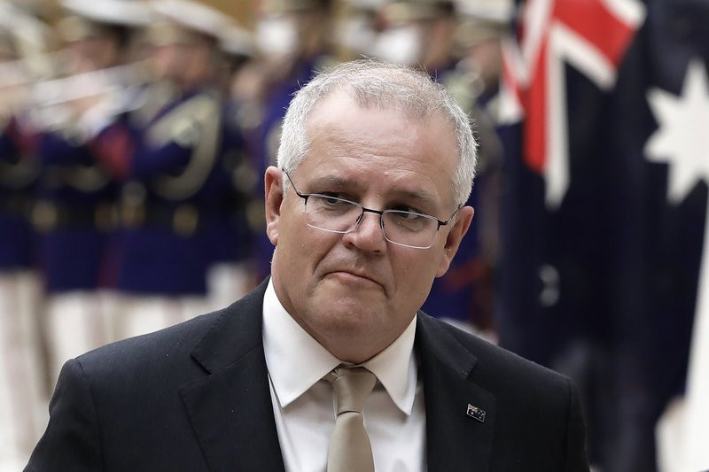 In this Nov. 17, 2020, file photo, Australian Prime Minister Scott Morrison reviews an honor guard during a ceremony ahead of a meeting at Japanese Prime Minister Yoshihide Suga's official re