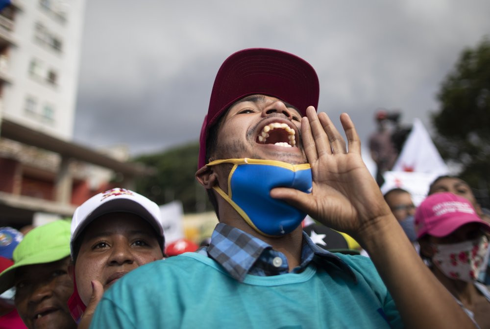 A government supporter shouts in support of parliamentary candidates representing the Great Patriotic Pole party at a closing campaign rally in Caracas, Venezuela, Thursday, Dec. 3, 2020.