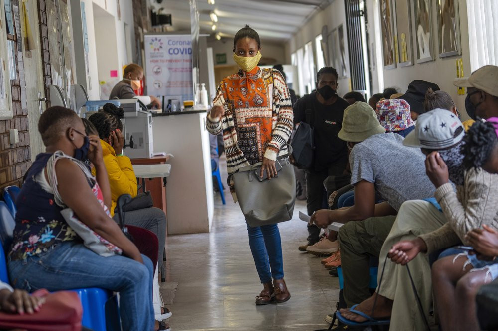 Volunteers wait to be checked at a vaccine trial facility for AstraZeneca at Soweto's Chris Sani Baragwanath Hospital outside Johannesburg, South Africa, Monday Nov. 30, 2020.