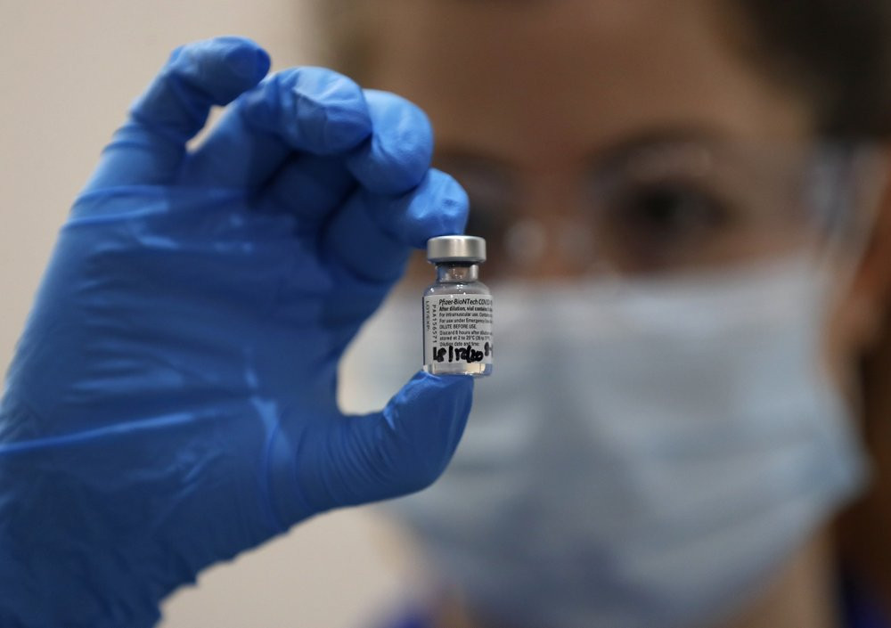 A nurse holds a phial of the Pfizer-BioNTech COVID-19 vaccine at Guy's Hospital in London, Tuesday, Dec. 8, 2020, as the U.K. health authorities rolled out a national mass vaccination program