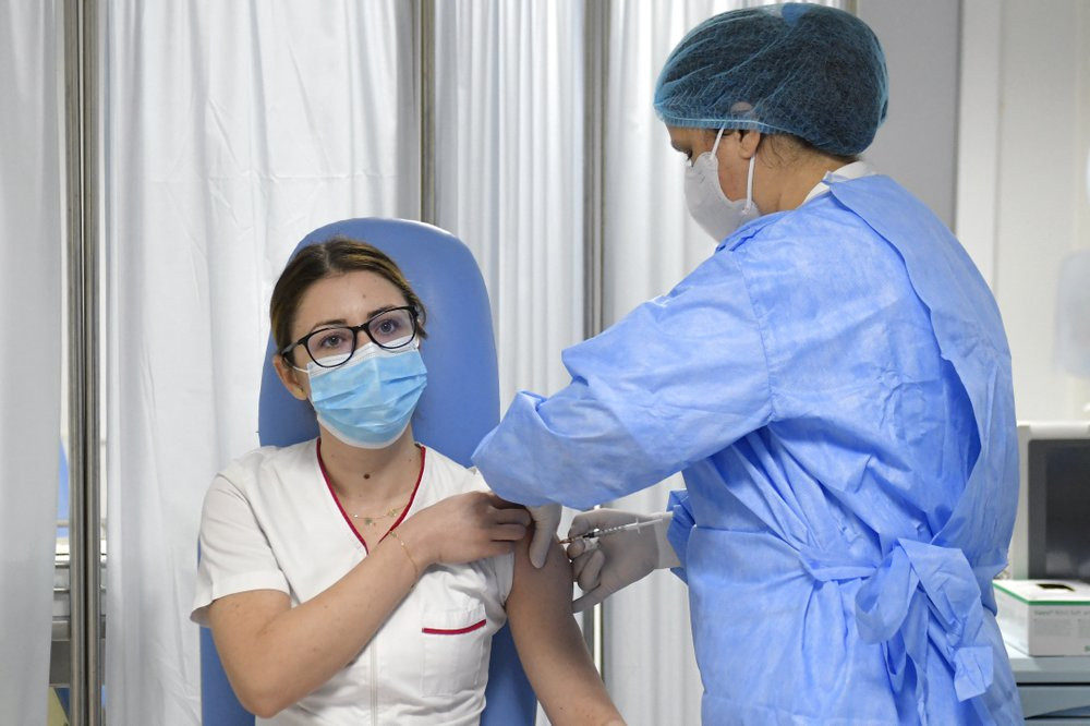 Mihaela Anghel, a Romanian nurse, gets the first COVID-19 vaccine administered in the country in Bucharest, Romania, Sunday, Dec. 27, 2020.