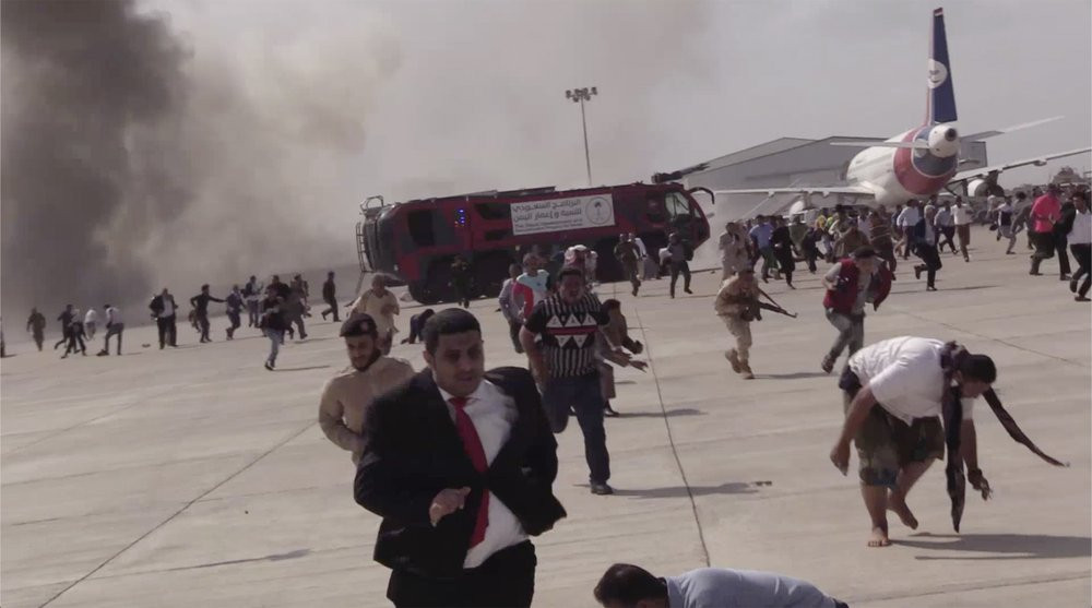 People run following an explosion at the airport in Aden, Yemen, shortly after a plane carrying the newly formed Cabinet landed on Wednesday, Dec. 30, 2020. No one on board the government pla