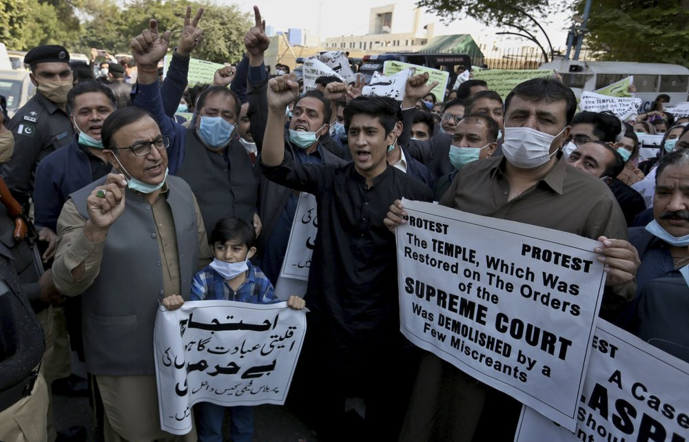 Members of Pakistan Hindu Council hold a protest against the attack on a Hindu temple in the northwestern town of Karak, in Karachi, Pakistan, Thursday, Dec. 31, 2020.