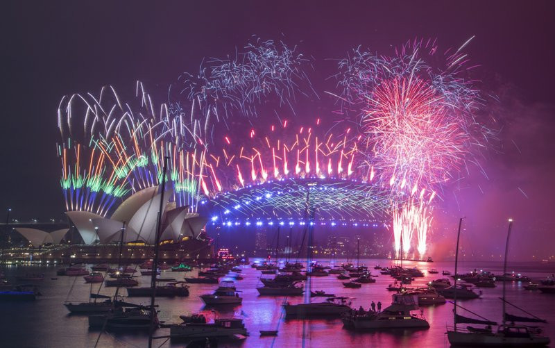 Fireworks explode over the Sydney Opera House and Harbour Bridge as New Year celebrations begin in Sydney, Australia, Friday, Jan. 1, 2021.